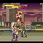 Street Fighter II gameplay screenshot with characters fighting on a city rooftop.