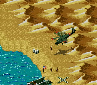 Fighter jet flying over desert coastline with soldiers and military equipment.