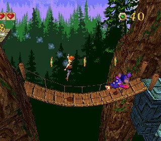 Gameplay screenshot from Pandemonium 1 showing characters on a wooden bridge.