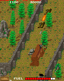 Arcade tank game screenshot with tanks, trees, and explosions.