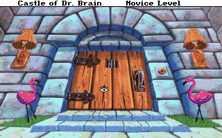 Game image of Castle Dr Brain with a wooden door and flamingo statues.