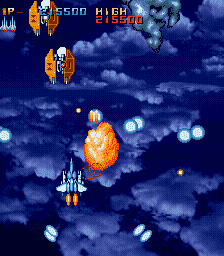 Gameplay screenshot of a retro arcade space shooter game with ships and explosions.