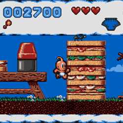 Screenshot of Bubsy game showing Bubsy jumping on a platform with a blue sky background.