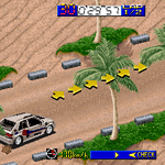 Racing game screenshot with cars, palm trees, and track obstacles.