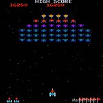 Classic arcade game Galaga with spaceship shooting alien enemies.