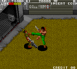 Retro arcade fighting game screenshot featuring a character executing a kick move.