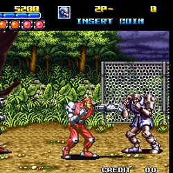 Arcade game screenshot featuring characters fighting near a goalpost.