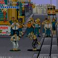 Arcade game screenshot of Street Fighter II with characters fighting on city street.