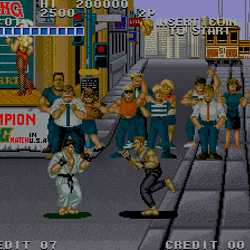 Arcade game screenshot of Street Fighter II with characters fighting on city street.