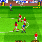 Classic soccer game with players in red and blue jerseys on a green field.