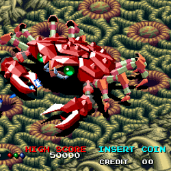 Pixel art of a red crab in a vintage arcade game scene.