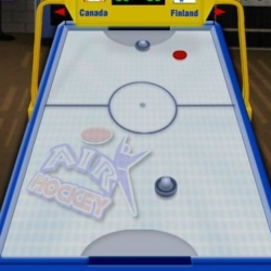 Air Hockey game with Canadian and Finnish flags in the background.