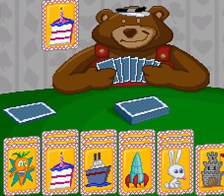Colorful digital image of a classic card game featuring a teddy bear with playing cards, vibrant card designs, and playful theme.