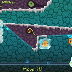 Golden goldfish trapped in ice cubes in a puzzle game scene.