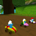 Colorful Smurf characters racing in go-karts in a vibrant outdoor setting.