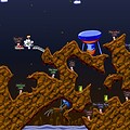 Multiplayer Worms game with colorful characters and terrain.