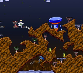 Multiplayer Worms game with colorful characters and terrain.
